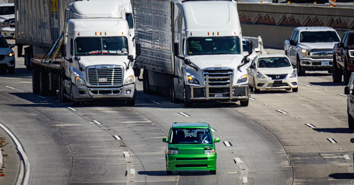 Cars and trucks on a multi-lane highway with lane markings clearly visible from above